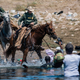 Mounted U.S. Border Patrol agents attempt to contain migrants as they cross the Rio Grande from Ciudad Acuña, Mexico, into Del Rio, Texas, Sept. 19, 2021.